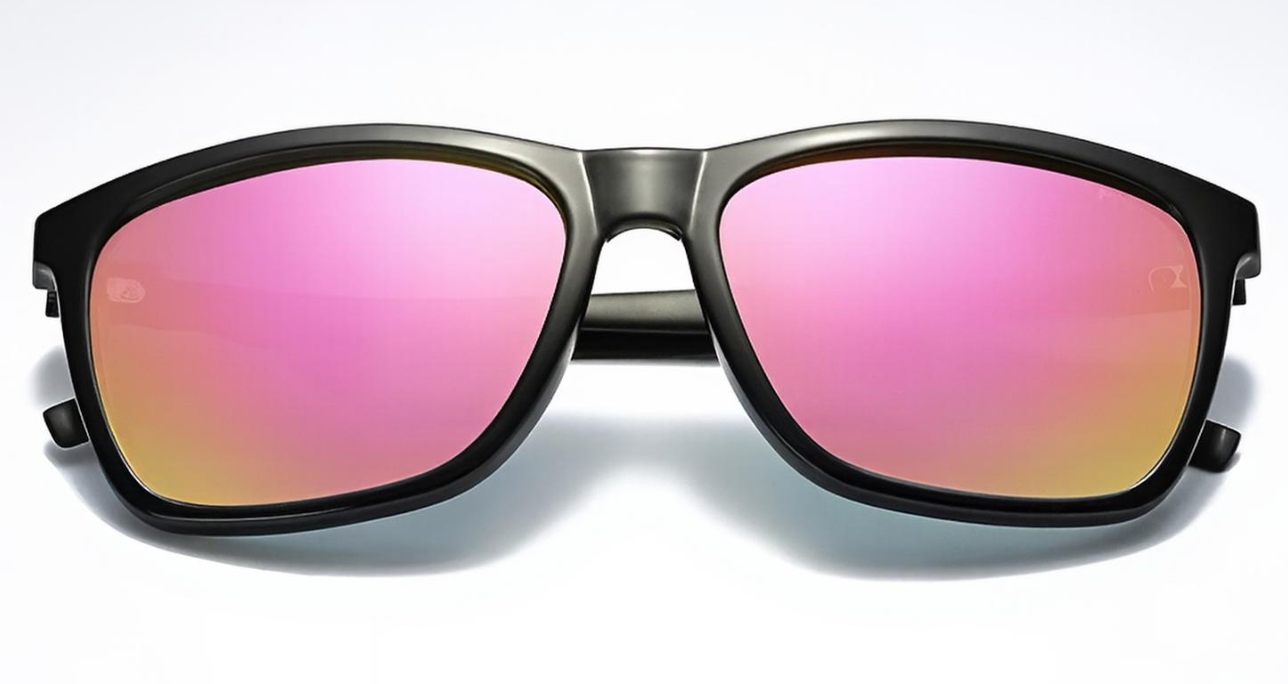 Mayfair - A pair of oversized square UV 400 polarised sunglasses with a matte black frame and vibrant pink-to-yellow mirrored lenses, shown against a clean white background - Missandtrendy