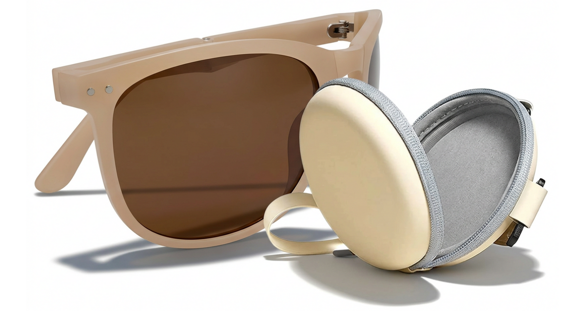 A pair of Convert  oversized square uv polarised sunglasses with thick beige frames and dark brown lenses, shown alongside an oval matching beige hard case with a gray zipper and interior lining on a white background.
