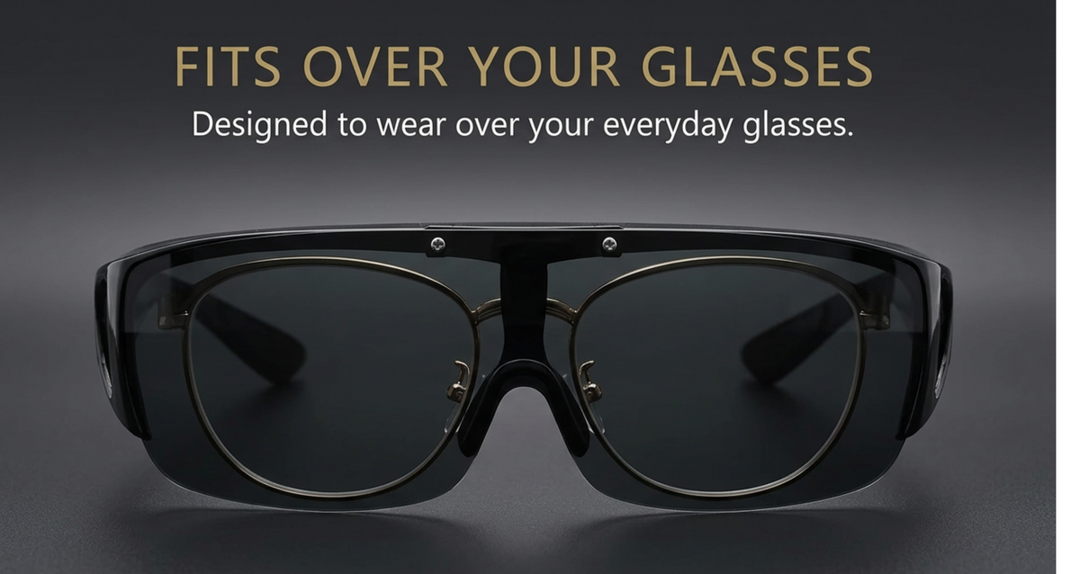 Black smart glasses with a sleek frame and dark uv polarised lenses, shown from the front on a dark gray background with the text 'FITS OVER YOUR GLASSES' and 'Designed to wear over your everyday glasses.'.