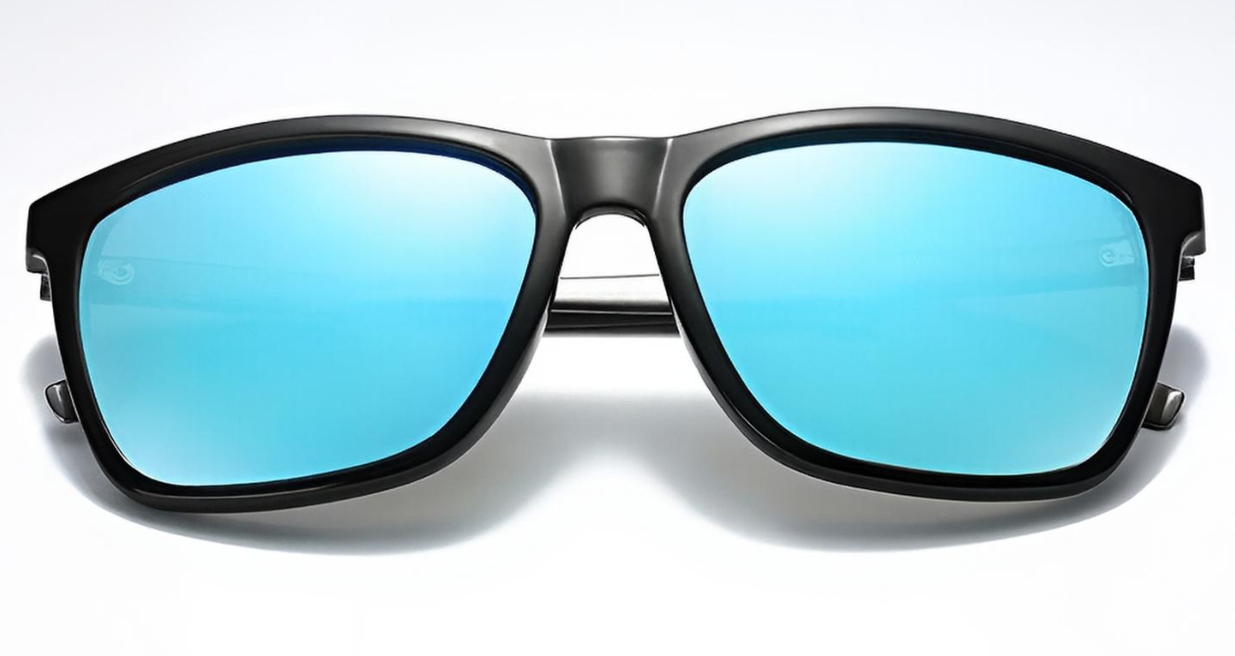 Mayfair - A pair of oversized square UV 400 polarised sunglasses with a matte black frame and vibrant blue mirrored lenses, shown from a front-facing perspective on a clean white background - Missandtrendy