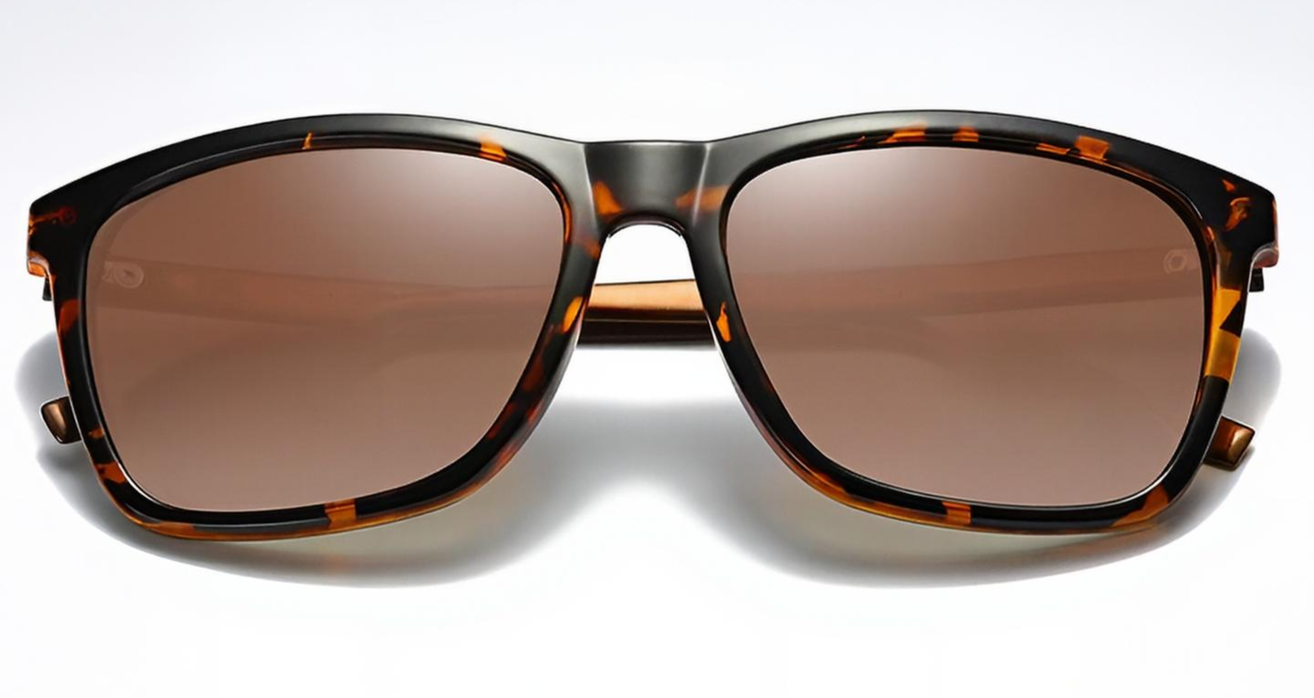 Mayfair - A pair of oversized square UV 400 polarised sunglasses with a glossy dark brown and amber tortoiseshell frame and matching brown-tinted lenses, shown against a clean white background - Missandtrendy
