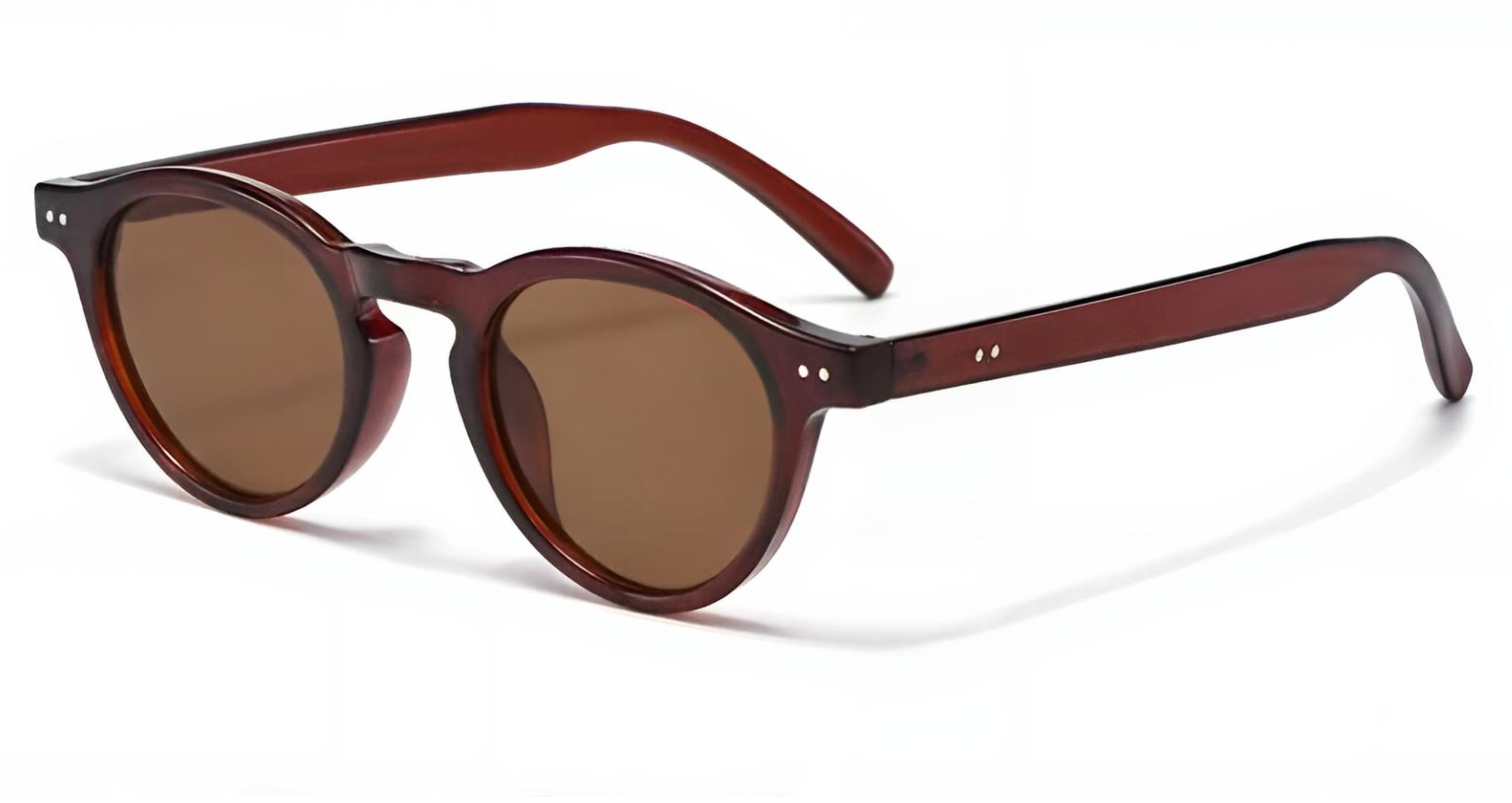 Sevilla - Round sunglasses with translucent dark reddish-brown frames and brown tinted lenses, shown on a clean white background - Missandtrendy