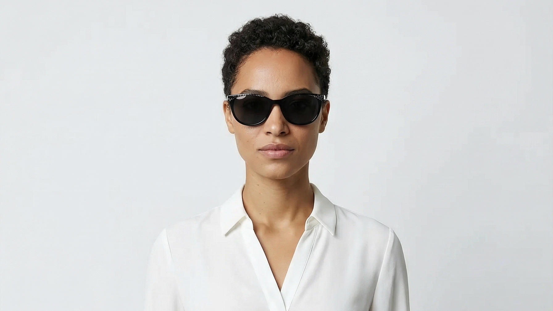 Woman wearing cat-eye black frame and black lens cat-eye sunglasses by Missandtrendy front side view