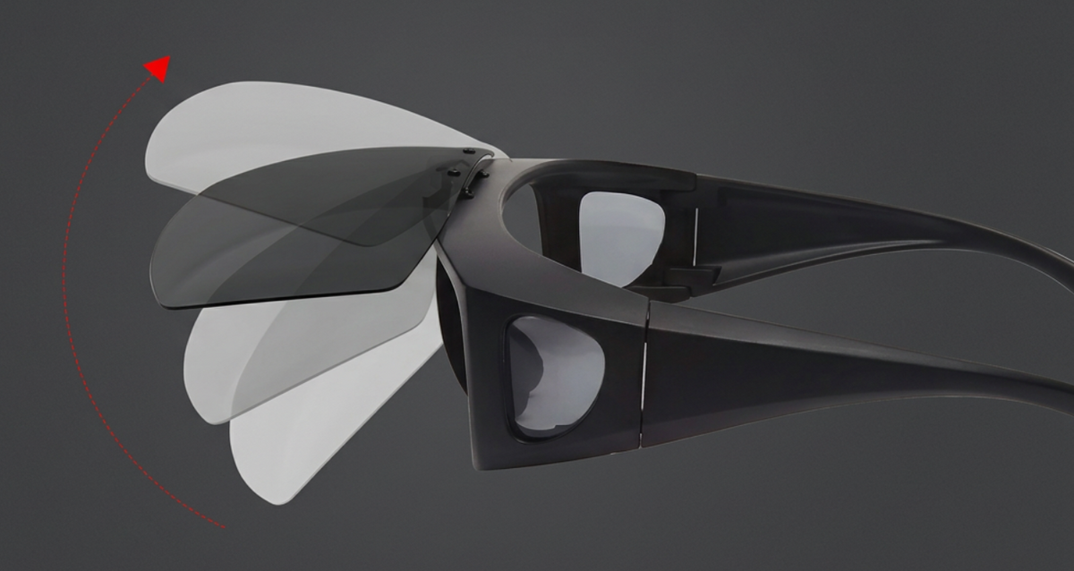 Black wraparound Photochromic UV 400 Polarised Sunglasses with translucent tinted lenses shown at an angle on a dark gray background, with a red arrow and curved red line indicating a rotation or adjustment feature.