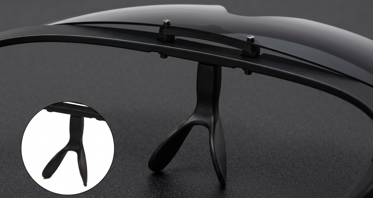 Close-up of black Photochromic UV 400 Polarised Sunglasses with a glossy curved upper frame, a central bridge, and a circular inset showing the temple arm detail on a dark textured background.